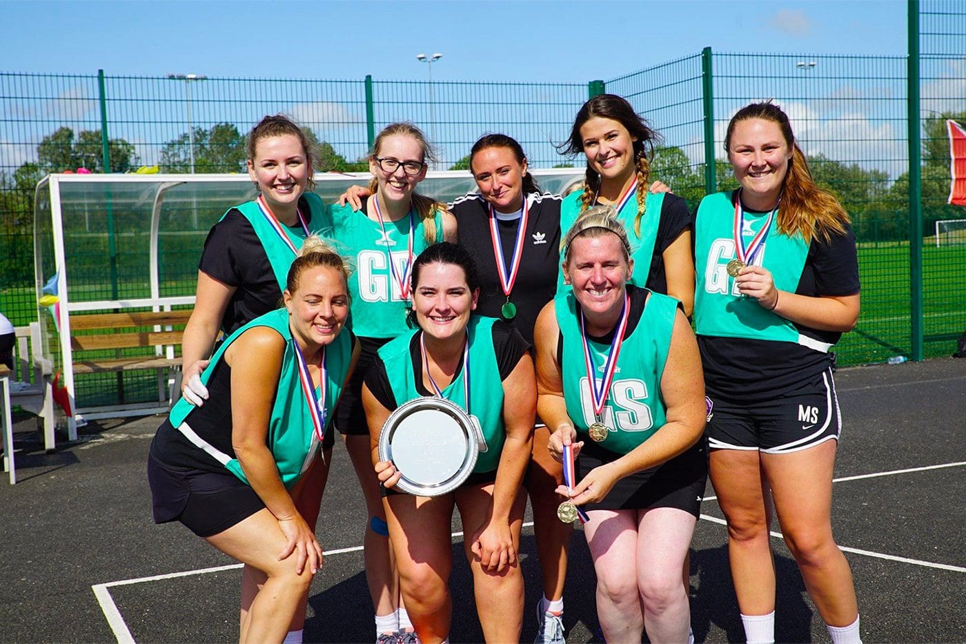 Image of netball team holding their awards Image of netball team holding their awards